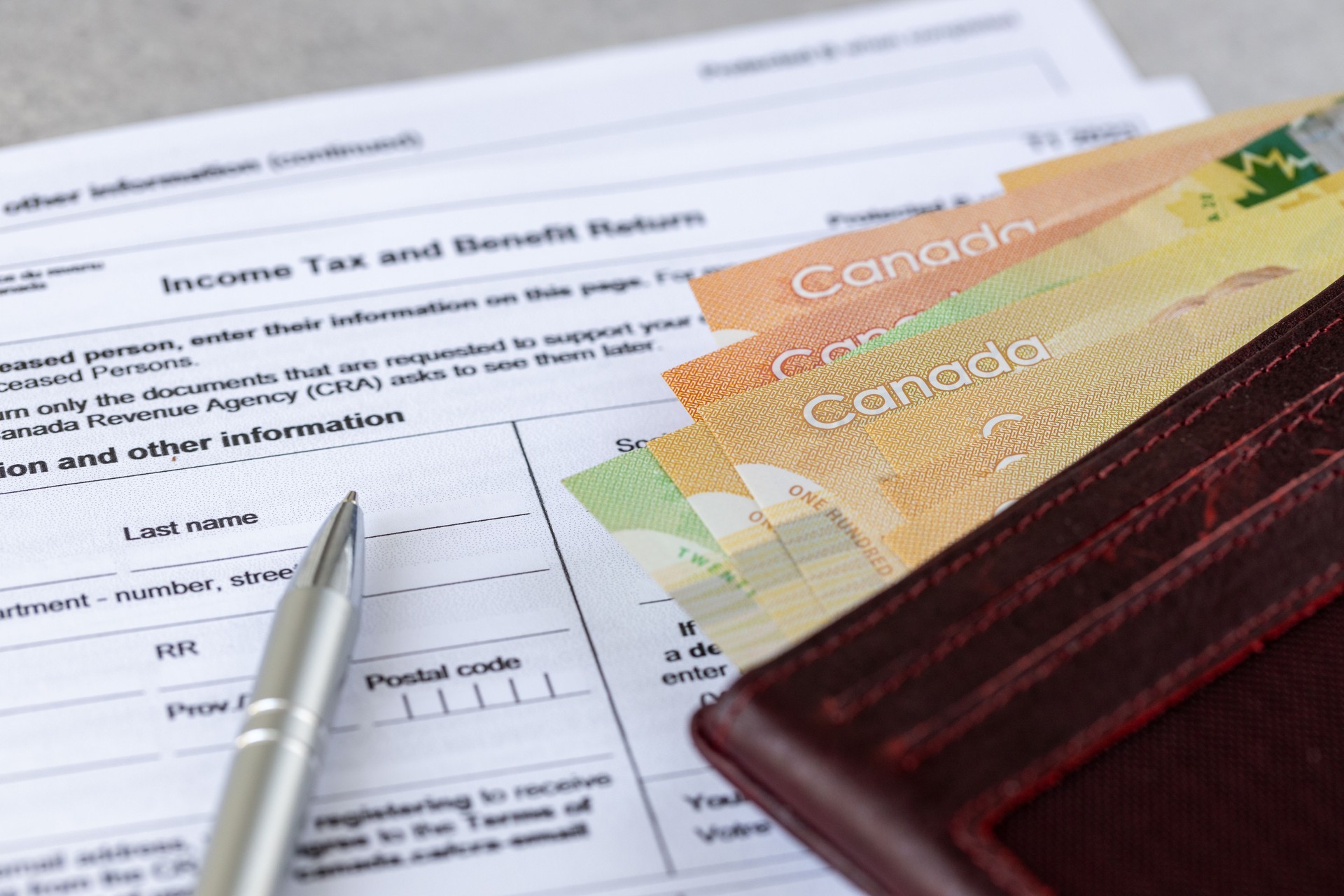 Canada. Income tax and benefit return. tax forms and Canadian dollars and pen, financial concept. close up
