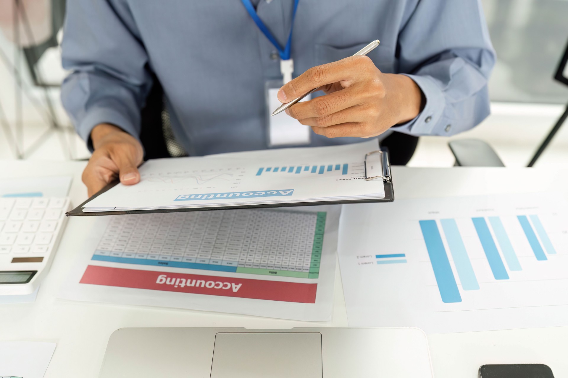 Financial Analysis and Reporting. Professional examining financial documents at desk.